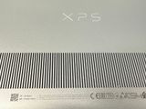 the back of a silver laptop computer with a keyboard on top of it