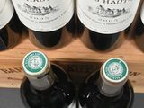 several bottles of wine sit on a shelf in a store