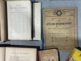 many old books on a table with a blue table cloth