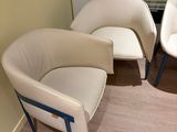 two chairs that are next to each other in a room