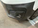 a close up of the front bumper of a white van