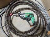 a hose with a drill attached to it on the ground