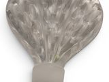 a shell shaped object on a white surface