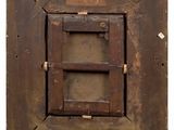 an old wooden picture frame with a window and a sign on it
