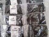 many bags of black underwear sitting on a table