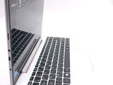 a white laptop with a black keyboard on a white surface