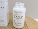 a bottle of olaplex on a table next to a box of olaplex
