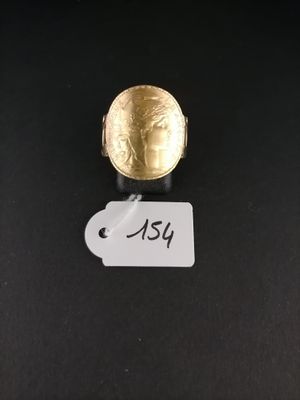 a close up of a gold ring on a black surface