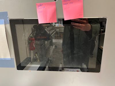 a person taking a picture of a microwave with post - it notes on it