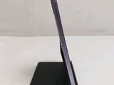 a close up of a cell phone on a stand on a table
