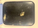 a black tray with a blue lid sitting on a table