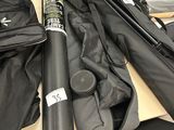 a black umbrella sitting on top of a table next to other items