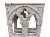 a stone sculpture of a cross in a window
