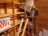 a room with shelves and a ladder in it