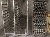 two racks with trays of food in the middle of a room