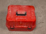 a red box with a handle on the ground