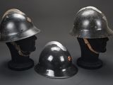 three helmets are sitting on top of each other on a black surface