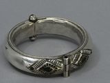 an image of a silver bracelet with a black stone in the center