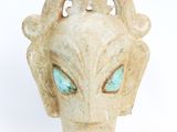 an image of a statue of an alien head with blue eyes