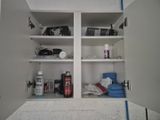 a white cabinet with a lot of items on it