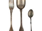 a spoon, fork, and spoon rest next to each other