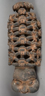 an image of a wooden sculpture of a man ' s head with many faces