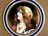 a picture of a picture of a woman in a gold and blue frame