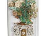 a glass dome with flowers inside of it on a wooden stand