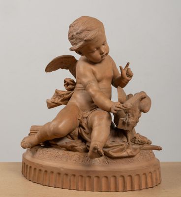 statue of a child with a bird and a dog on a table