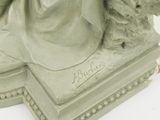 a statue of a woman and a dog on a pedestal
