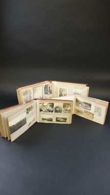 five old books with pictures on them sitting on a black surface