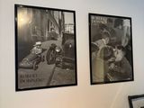 une photo d'un bureau avec un ordinateur et des photos accrochées au mur