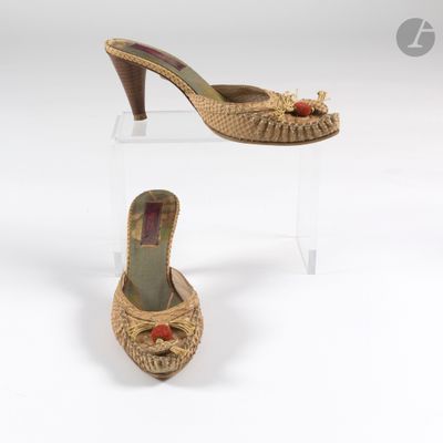 Deux paires de chaussures sont exposées sur un présentoir transparent