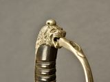 a close up of a sword with a lion head on it