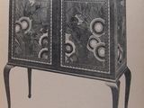 an open book with a picture of a cabinet on it