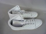pair of white tennis shoes with white laces on them on a white surface