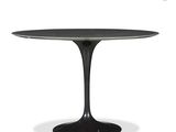 a black table with a white top and a black base