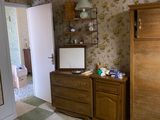 a bedroom with a dresser, mirror, and a dresser in it