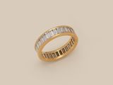 an 18k yellow gold ring with baguets of diamonds
