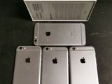 four iphones are sitting next to each other on a table