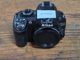 a camera sitting on a wooden table with a tag on it