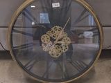 a clock that is sitting on the floor in front of a couch