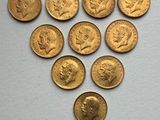 a close up of a bunch of gold coins on a white surface