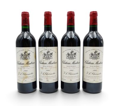 three bottles of wine are lined up on a white surface