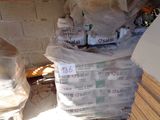 a pile of bags of food sitting on the ground