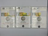 three silver coins sitting on top of each other next to each other