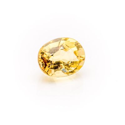 a yellow sapphire stone on a white background