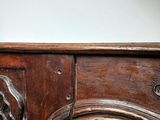a close up of a wooden table with a clock on it