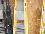 three ladders that are next to each other in a room