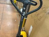a fork lifter that is sitting on a pallet in a warehouse